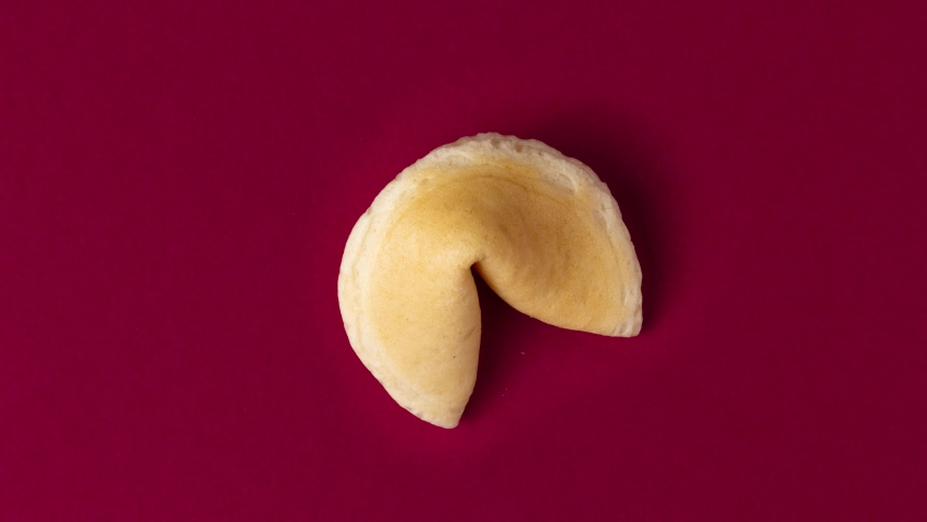 a stopmotion of a fortune cookie cracking and showing a prophecy, saying good luck Royalty-Free Stock Footage #1081390727