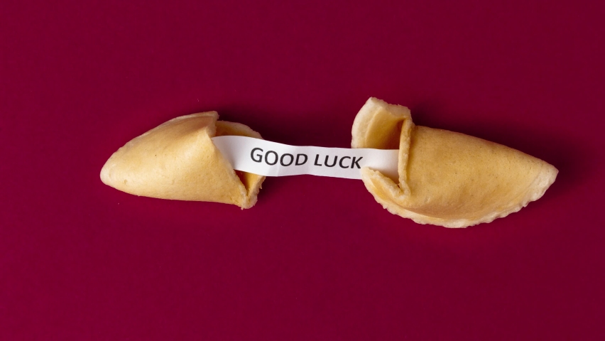 A stopmotion of a fortune cookie cracking and showing a prophecy, saying good luck | Shutterstock HD Video #1081390727
