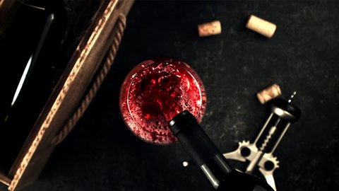 Super slow motion from the bottle pour the wine into the glass. Top view. On a black background. Filmed on a high-speed camera at 1000 fps.High quality FullHD footage