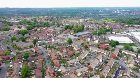 Aerial drone footage of the town of Bramley which is a district in west Leeds, West Yorkshire, England UK, showing residential housing estates, and semi detached houses in the summer time