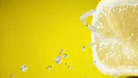 Squeezing out fresh Lemon juice drains from the pulp on yellow background Super slow-mo 1000 fps - Powered by Shutterstock - Get 15% off with code: PIKWIZARD15