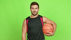 Handsome man holding a basket ball over isolated background