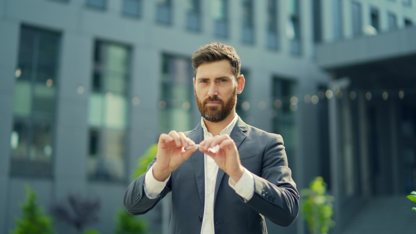 Happy smiling successful man breaks a cigarette and quits smoking. businessman breaking a cigarette. Stop smoking. World No Tobacco Day for his good health. He broke splitting in two Royalty-Free Stock Footage #1081400909