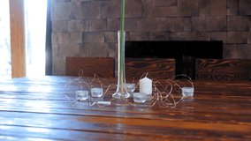 Woman standing decoration candles on table for holiday dinner. Restaurant designer preparing eve dinner table with decorative candles - Powered by Shutterstock - Get 15% off with code: PIKWIZARD15