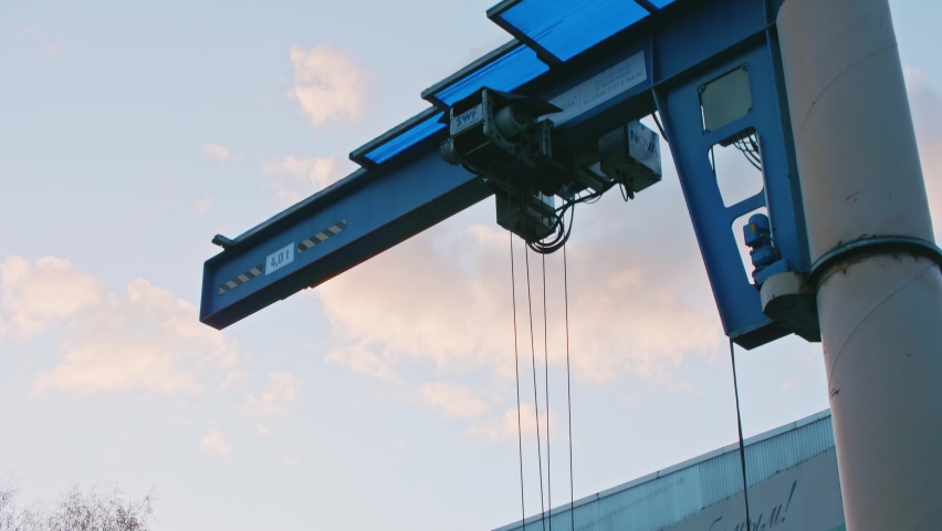 View of erection truss with cloudy sky at background. Lifting loads near river.