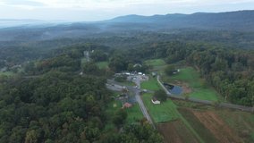 Aerial camera pushing into view of rural elementary school in the West Virginia Appalachian mountains on a crisp autumn morning.