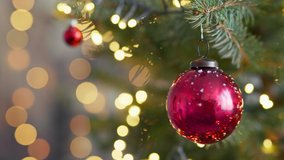 Happy New Year Christmas tree decorates with red glass ball on branch snow on background bokeh of side flickering light bulbs garlands for family winter holiday. Festival mood. Noel - Powered by Shutterstock - Get 15% off with code: PIKWIZARD15