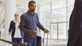 Indian passenger showing e-ticket to flight attendant at boarding gate. Middle eastern businessman showing boarding pass on mobile phone to air hostess. Multiethnic business man showing eticket. - Powered by Shutterstock - Get 15% off with code: PIKWIZARD15