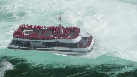 Niagara Falls , Ontario , Canada - 10 26 2021: Tourists enjoying the spectacular view of the Niagara Falls.