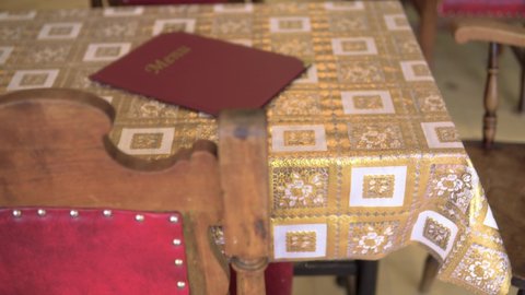 Luxurious vintage style table with menu red and golden color placed on top ready for customer creative close up smooth slow motion