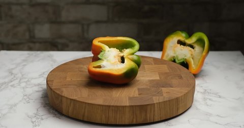 Cutting bell peppers on a cutting board.