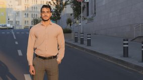 Hispanic handsome young business man arabic bearded manager worker boss leader guy entrepreneur in formal clothes stands in city street background crossing arms posing confidently looking at camera
