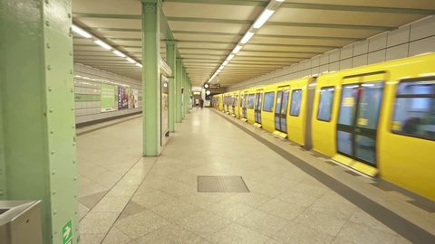 BERLIN, GERMANY - July 15, 2021: Yellow train in empty Berlin metro platform, U Bahn underground subway. German urban lifestyle, tourism destination in Germany.