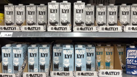 London UK - October 28th 2021 - Rows of Oatly milk cartons in a supermarket. Oatly is a dairy free vegan milk alternative.