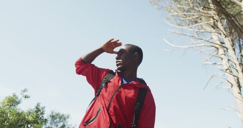 African american man looking away and hiking in countryside. healthy, active lifestyle and outdoor leisure time.