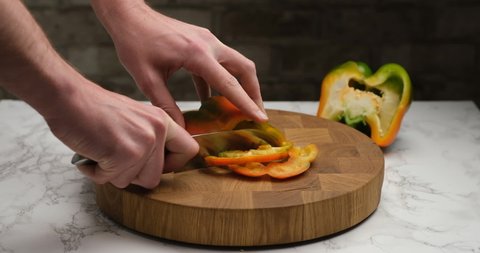 Cutting bell peppers on a cutting board.
