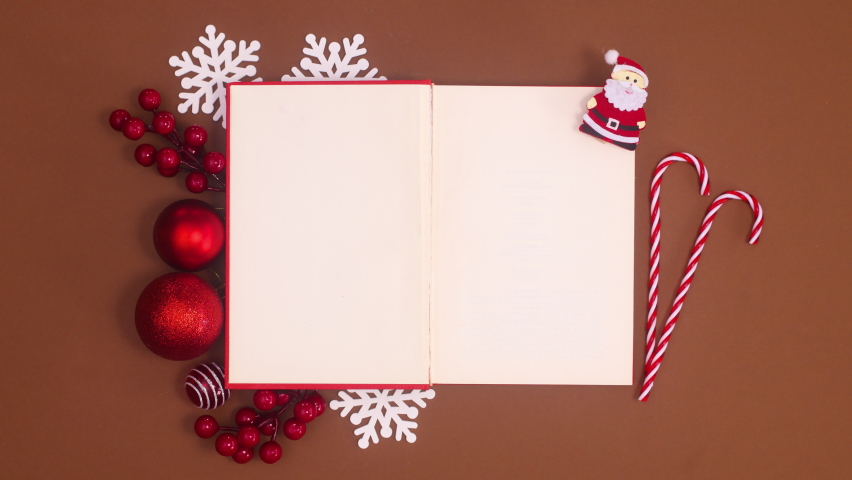 6k Red book open and Christmas ornaments appear around book. Stop motion Royalty-Free Stock Footage #1081453343