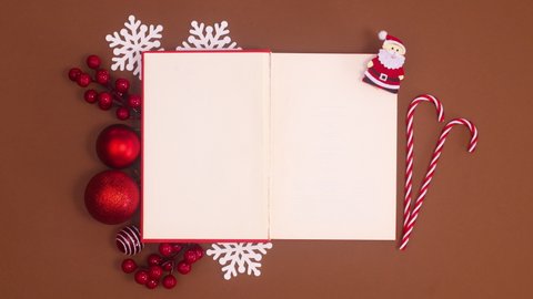 6k Red book open and Christmas ornaments appear around book. Stop motion