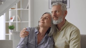 Happy affectionate mature adult husband embracing kissing wife enjoying tender moment or love and care. Middle age 50s romantic grey haired married couple bonding together, hugging at home. - Powered by Shutterstock - Get 15% off with code: PIKWIZARD15