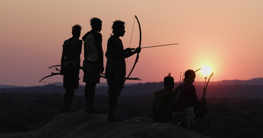 Group of Hadza hunter-gatherer tribesmen out hunting at sunset Tanzania Royalty-Free Stock Footage #1081454177