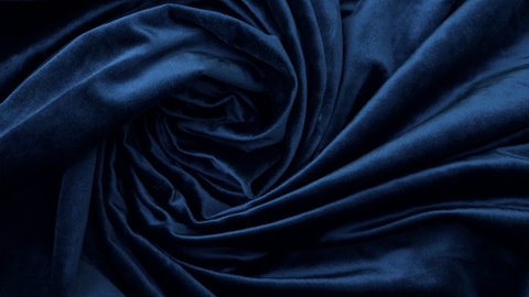 Elegant soft shiny dark blue, Oxford blue velvet fabric textile. Abstract fashion, interior fabric background. Rotating.