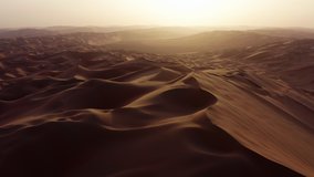 Drone flying over massive sand dunes at sunrise. Aerial bird view of desert landscape. Liwa desert, Abu Dhabi, United Arab Emirates. Epic cinematic background of arabic nature. - Powered by Shutterstock - Get 15% off with code: PIKWIZARD15