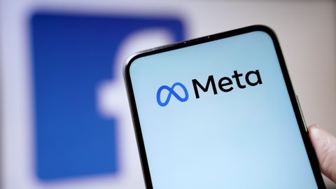 Cracow, Poland - October 29, 2021:  Mark Zuckerberg announced facebook logo change to meta and creates metaversum that integrates services. Brand change concept on smartphone and computer monitor.