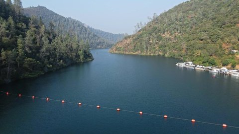 Buoys On Rope Floating At Lake Clementine Reservoir - Rainbow Below Arch Dam In Auburn, California, USA. - aerial, tilt down