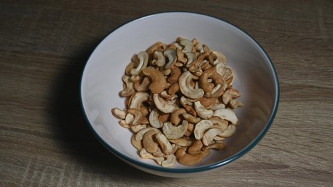 Zoom in of a Bowl with Cashew nuts on the table, a healthy source of protein and energy food.