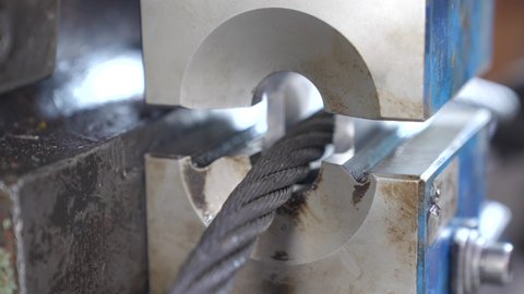Pulling steel wire rope through talurit swaged sleeve in hydraulic press, creating loop