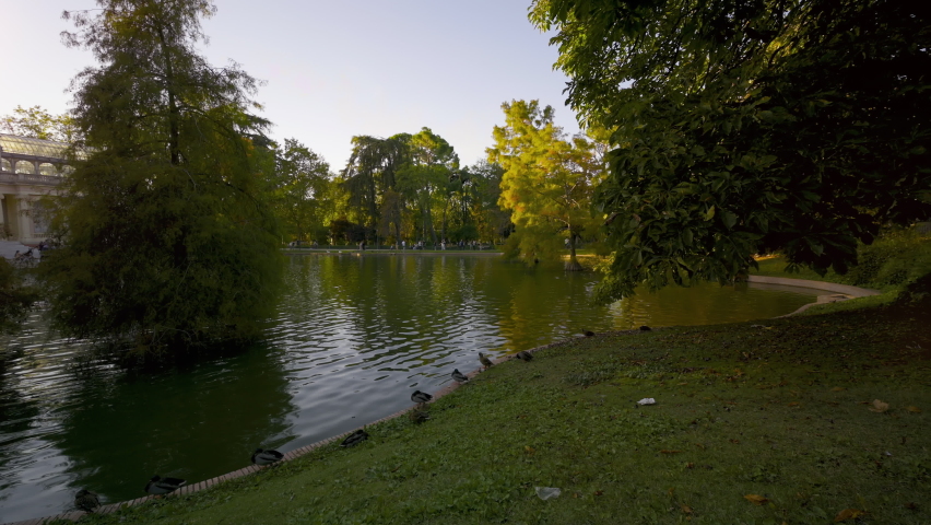Panning shot of a sunset view of Crystal Palace or Palacio de cristal in Retiro Park in Madrid, Spain. . High quality 4k footage