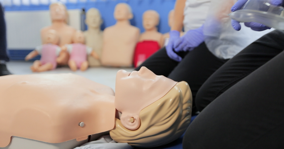 CPR training using and an AED and bag mask valve on an adult training manikin. Royalty-Free Stock Footage #1081465748