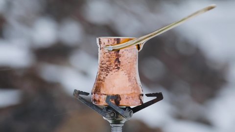 Copper Cezve for coffee in winter mountains