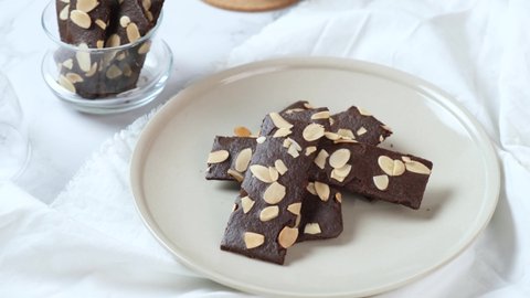 crunchy brittle brownie crisps crackers set on white cafe table.