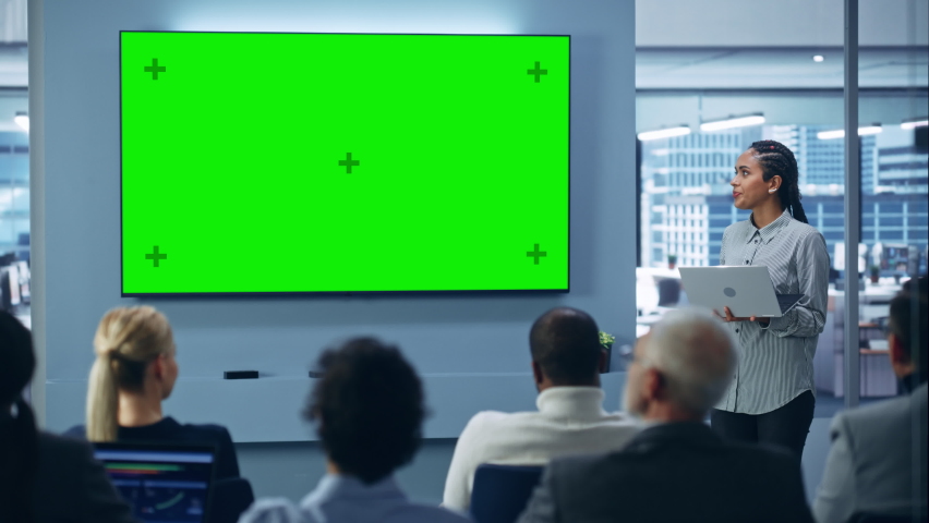 Modern Product Presentation Event: Black Businesswoman Speaks, Uses Green Chroma Key Screen Wall TV. Press Conference for Group of Diverse Investors, Digital Entrepreneurs, Businesspeople Royalty-Free Stock Footage #1081470185