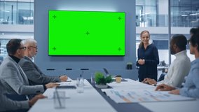 Office Conference Room Meeting Presentation: Beautiful Businesswoman Talks, Uses Green Screen Chroma Key Wall TV. Digital Entrepreneur Presents e-Commerce Product to Group of Multi-Ethnic Investors - Powered by Shutterstock - Get 15% off with code: PIKWIZARD15