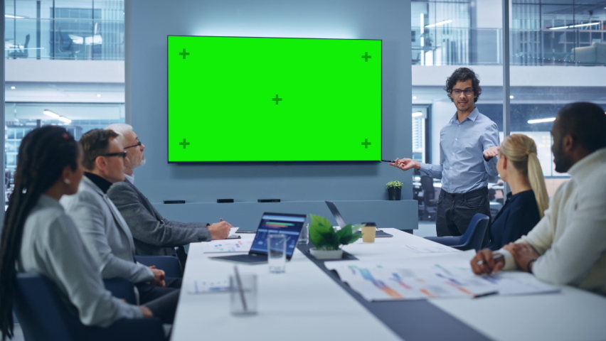Office Conference Room Meeting Presentation: Charismatic Latin Businessman Talks, Uses Green Screen Chroma Key Wall TV. Successfully Presenting a e-Commerce Product to Group of Multi-Ethnic Investors | Shutterstock HD Video #1081470230