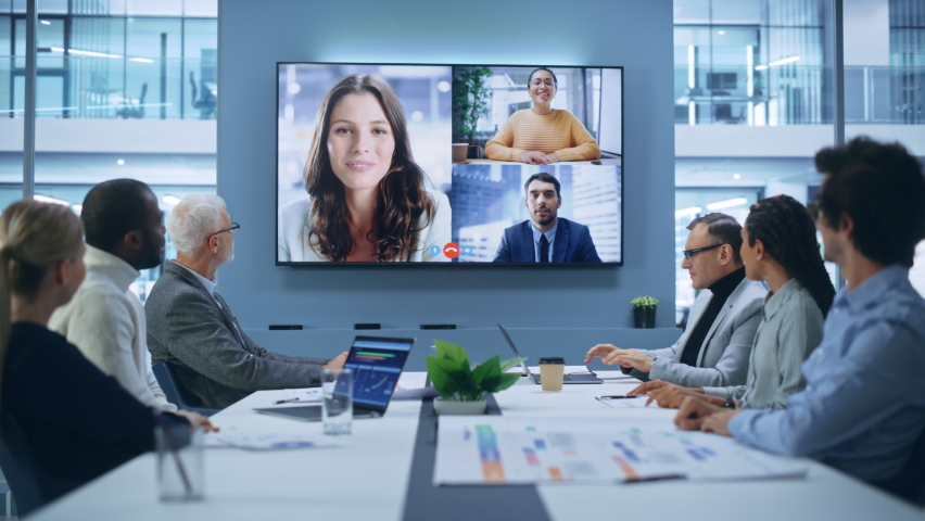 Video Conference Call in Office Boardroom Meeting Room: Executive Directors Talk with Group of Multi-Ethnic Entrepreneurs, Managers, Investors. Businesspeople Discuss e-Commerce Investment Strategy Royalty-Free Stock Footage #1081470257