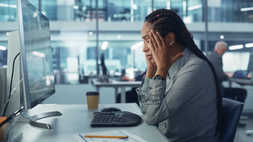 Black Female Corporate Office Worker Feels Stress, Frustration Works on Desktop Computer. Accountant Feeling Project Pressure, Massages Her Head, Works with Statistics, Has Bad Day. Stock Market Crash Royalty-Free Stock Footage #1081470377