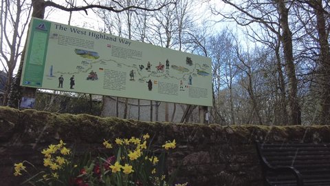 Milngavie, Glasgow; 05 April 2021: A pictorial notice board at the beginning of the West Highland Way walk at Milngavie, near Glasgow, Scotland. Filmed during a fall of hail.