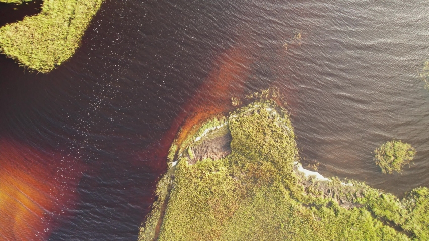 Aerial over Gulf Coast bay where fresh water has flooded it - brackish. Stock aerial 4k footage