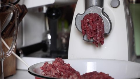 Preparation Of Minced Meat From Fresh Beef And Fresh Pork Through A Meat Grinder. Cooking Minced Meat At Home In The Kitchen. Dolly Slider Shot.