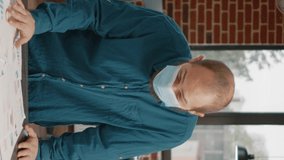 Portrait of businessman with face mask working on project strategy and planning. Engineer designing papers with data charts and analysis to create presentation during covid 19 pandemic. - Powered by Shutterstock - Get 15% off with code: PIKWIZARD15