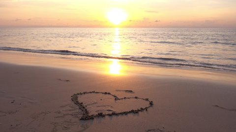 Heart symbol on beach, Hand drawn heart on beach sand over sunset or sunrise sky beautiful light nature landscape