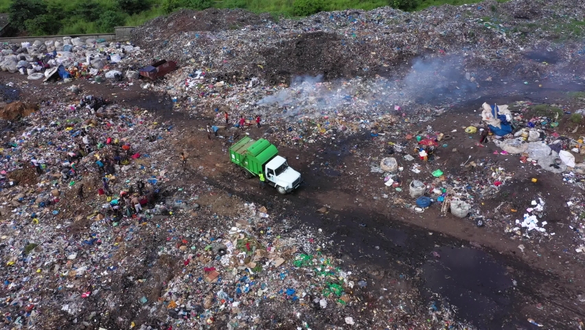 Aerial scavengers city garbage dump Freetown Sierra Leone circle. Coast west Africa suffers extreme poverty hunger. Congested crowded homes, slums and businesses. Tropical climate. Infrastructure. Royalty-Free Stock Footage #1081480718