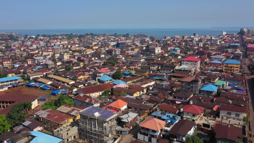 Aerial Freetown city congested building traffic. The coast of West Africa suffers extreme poverty and hunger. Congested crowded homes and businesses. Tropical climate.