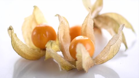Physalis fruit closeup. Groundcherry fruits rotated over white background. Ripe fresh Physalis plant, yellow berry. Cape gooseberry. Goldenberry. Slow motion 4K UHD video. 