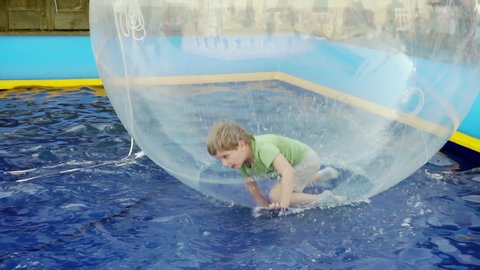 Transparent ball with a boy inside.