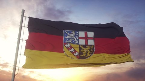 Saarland flag, Germany, waving in the wind, sky and sun background