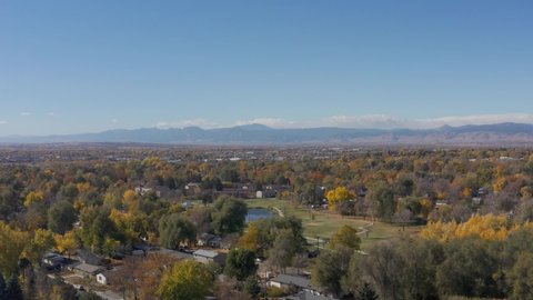 Longmont, Colorado Aerial 4K video. Drone flying up above northern Colorado city with view of front range mountains.